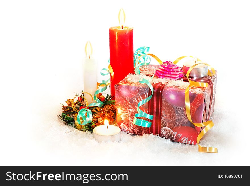 Christmas gifts with candles, snow and ribbons on white background. Christmas gifts with candles, snow and ribbons on white background