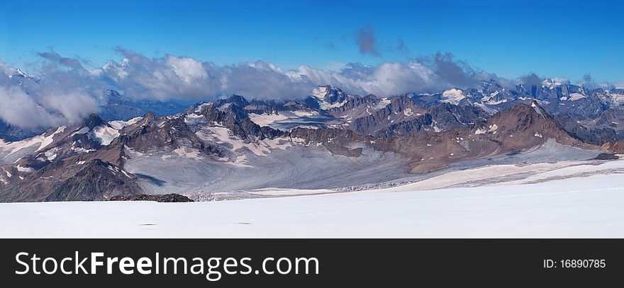 Panorama snow declivity and array of the mountains
