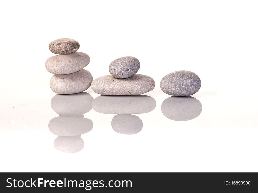 Six pebbles stacked isolated on white. Six pebbles stacked isolated on white