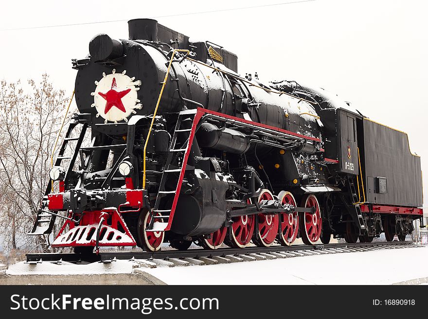 Old steam locomotive on a pedestal. Old steam locomotive on a pedestal