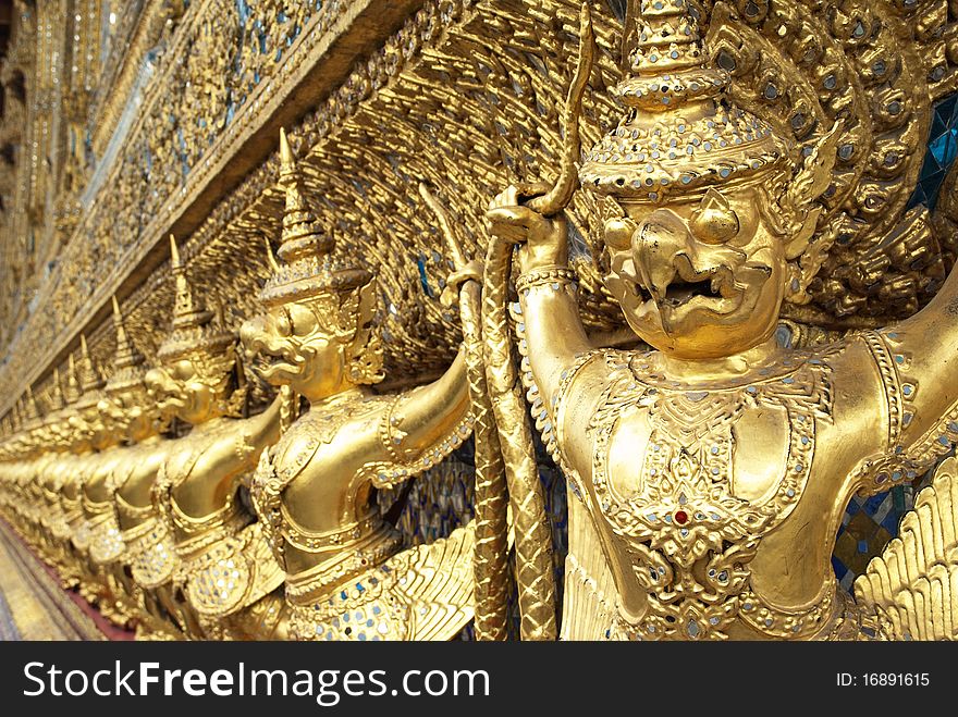 Many of golden garuda statue around buddhist church, Wat Phra Keaw, Bangkok, Thailand