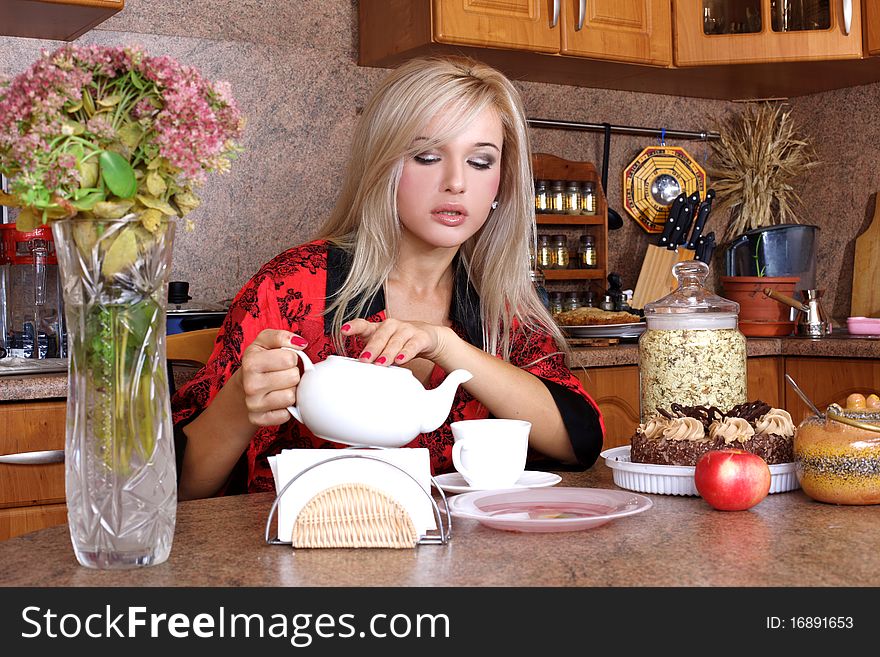 Woman breakfast with apple and cup of hot drink in the kitchen