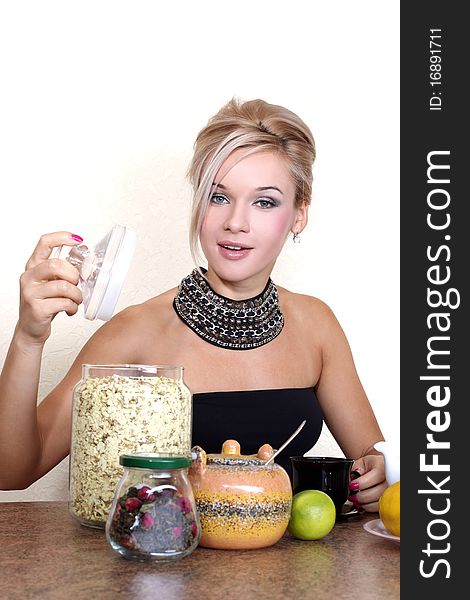 Woman with cup, lemon, lime, jasmin petals