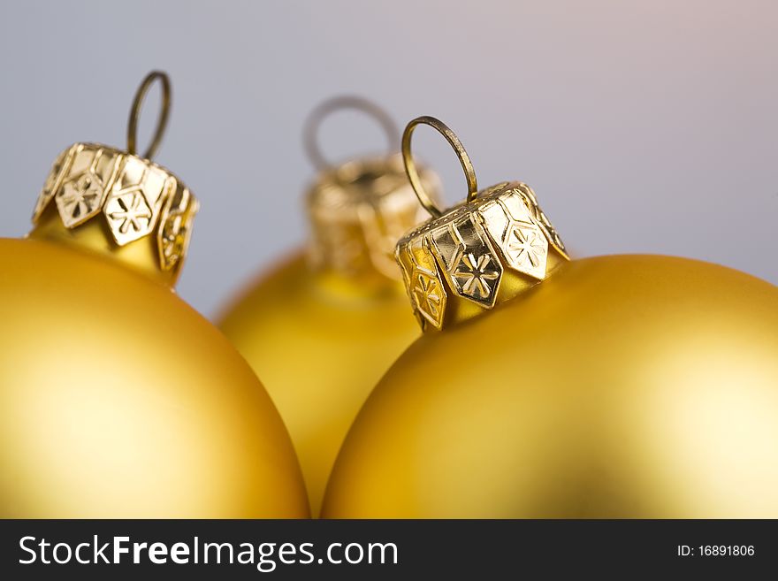 Christmas-tree decoration: closeup on top of three golden balls. Christmas-tree decoration: closeup on top of three golden balls.