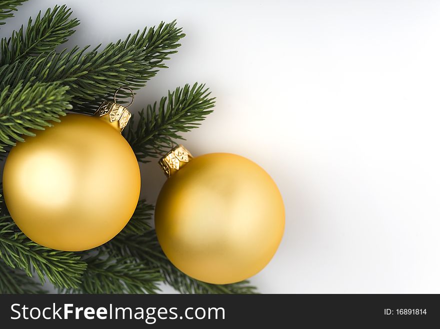 Christmas decoration: closeup on two golden balls and spruce branch. Space for your text or announcement. Christmas decoration: closeup on two golden balls and spruce branch. Space for your text or announcement.