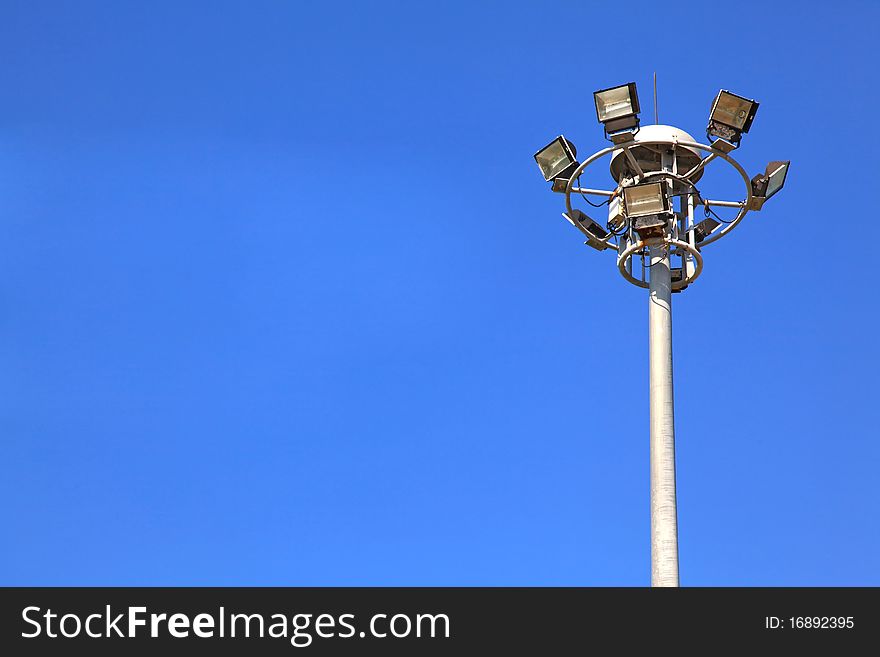 Spotlights post isolated on sunny blue sky