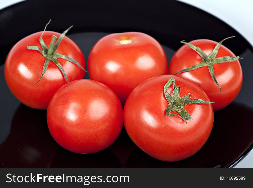 Tomatoes on black plate