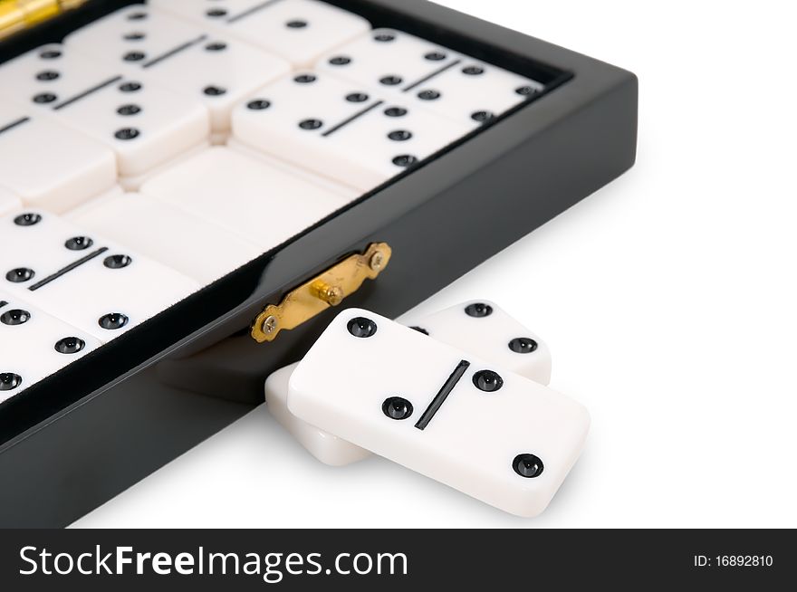 Casket with dominoes is photographed on the white background