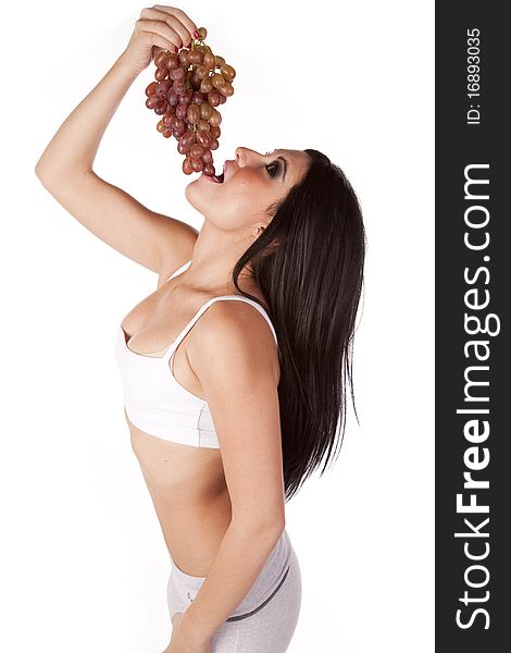 Woman Standing Putting Grapes In Mouth