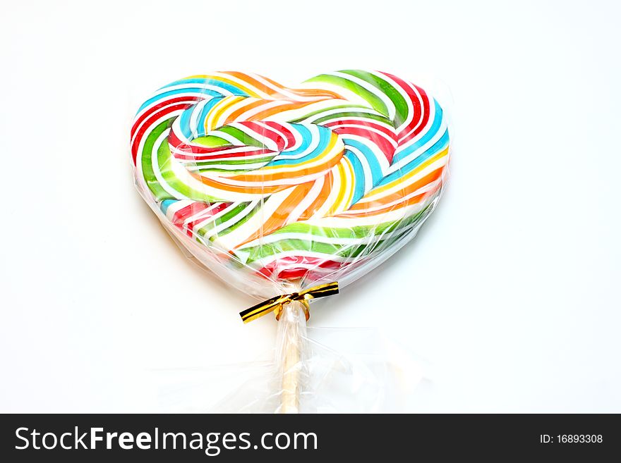 Close up of colourful lollipop, heart shape.