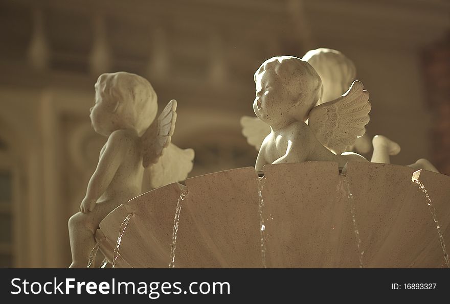 White color cupid statues on fountain. White color cupid statues on fountain