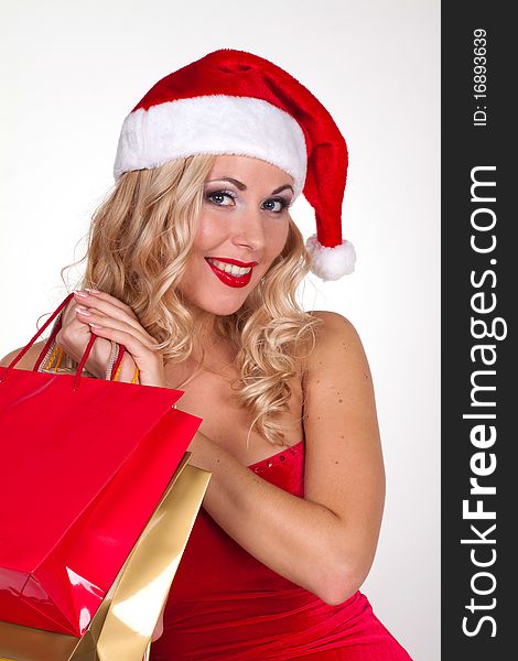 Beautiful blond girl in christmas costume with shopping bags