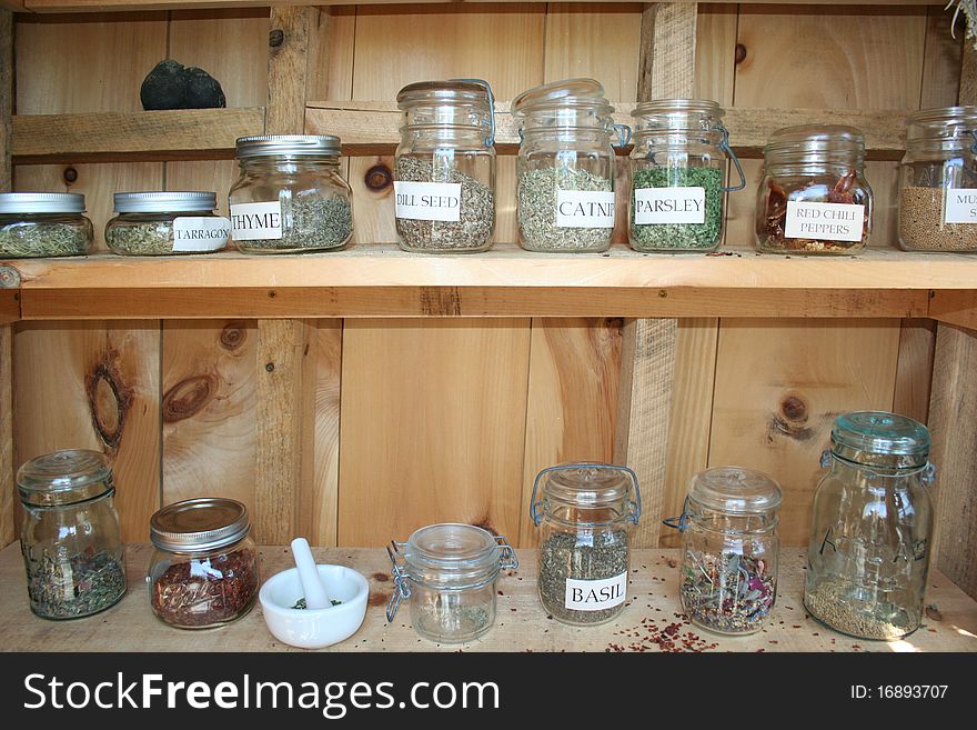 Dried herbs in bunches and jars for culinary and spa use. Dried herbs in bunches and jars for culinary and spa use