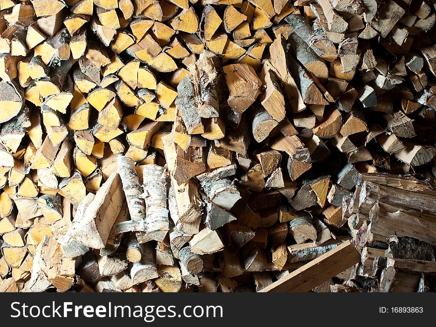 Stack of birch wood inside the woodshed. Stack of birch wood inside the woodshed.