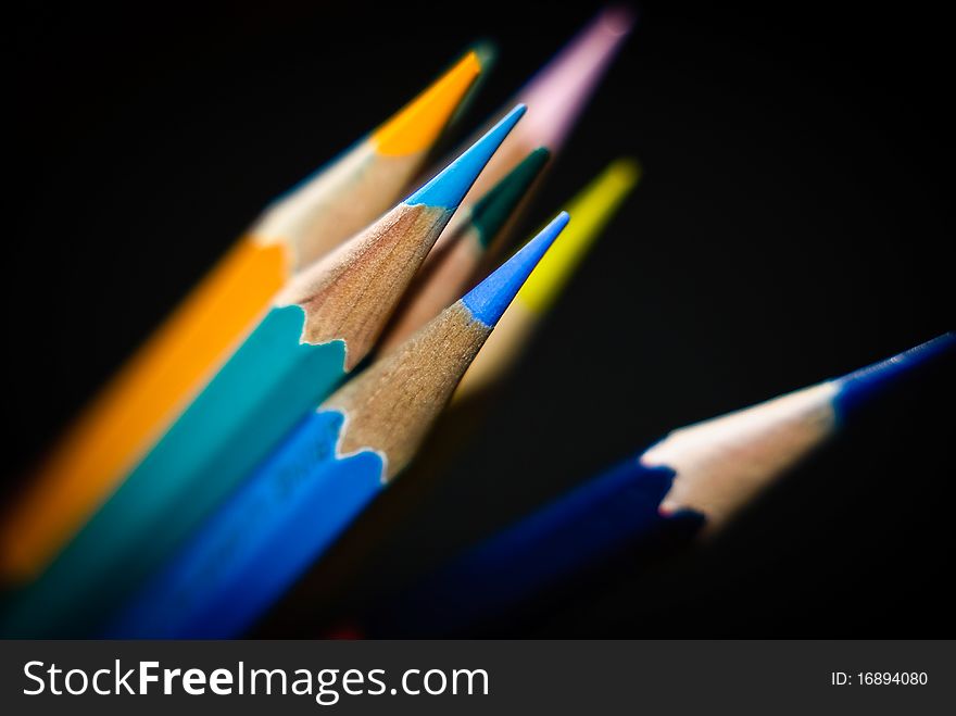 Color pencils arrange over  black background. Color pencils arrange over  black background