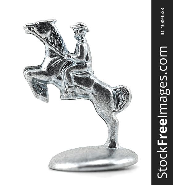 Studio shot of equestrian, jumping horse isolated on white. Table game silver metal figure.