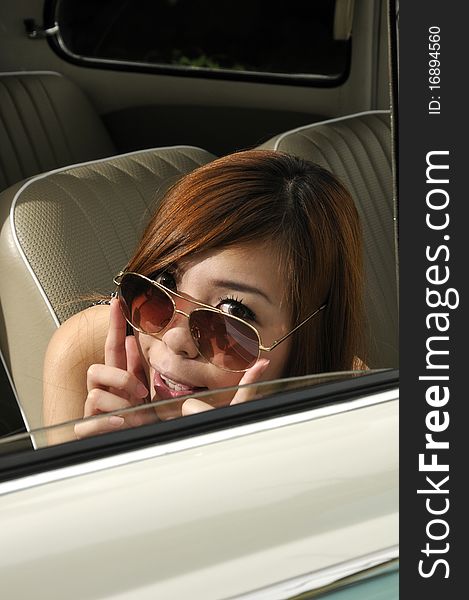 Girl in a car with sun glasses