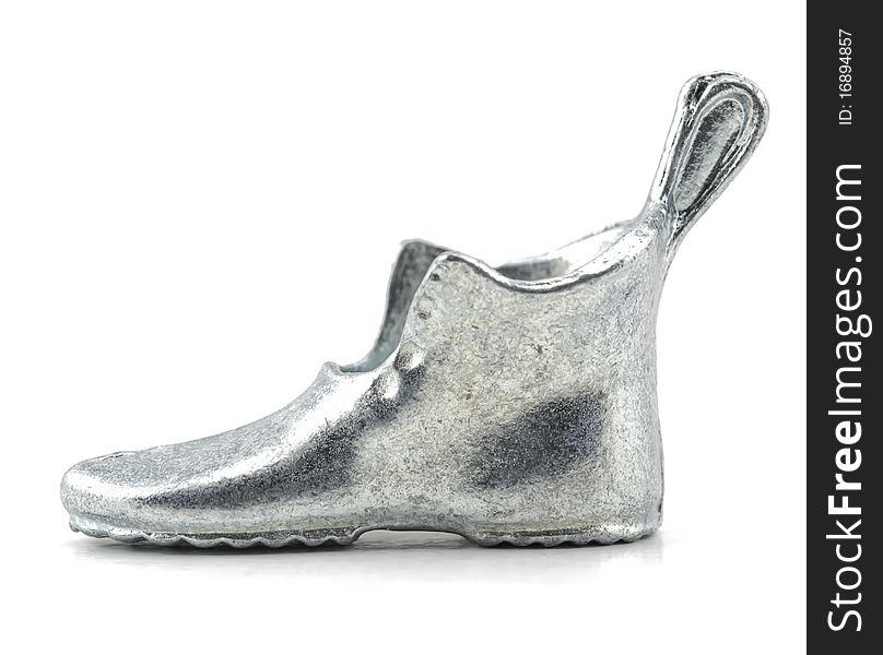 Studio shot of Silver high heel boot isolated on white.Table game silver metal figure.
