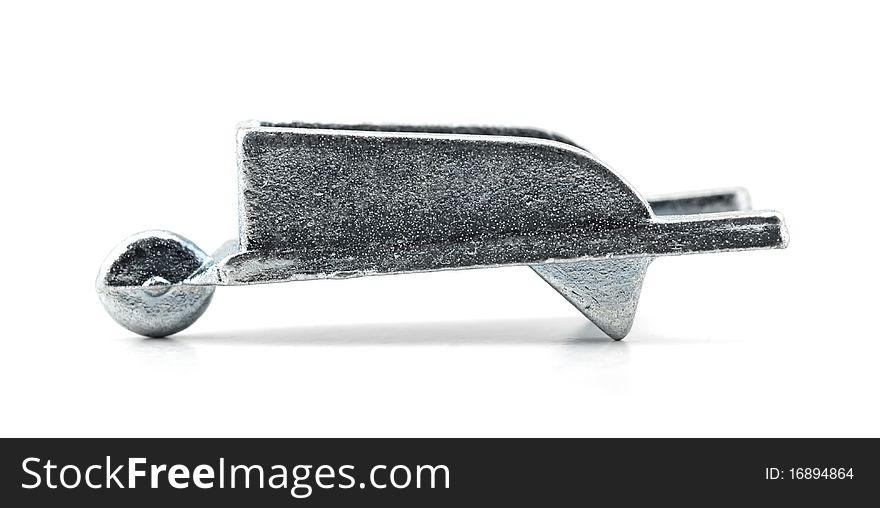 Studio shot of Wheelbarrow isolated on a white background .Table game silver metal figure.