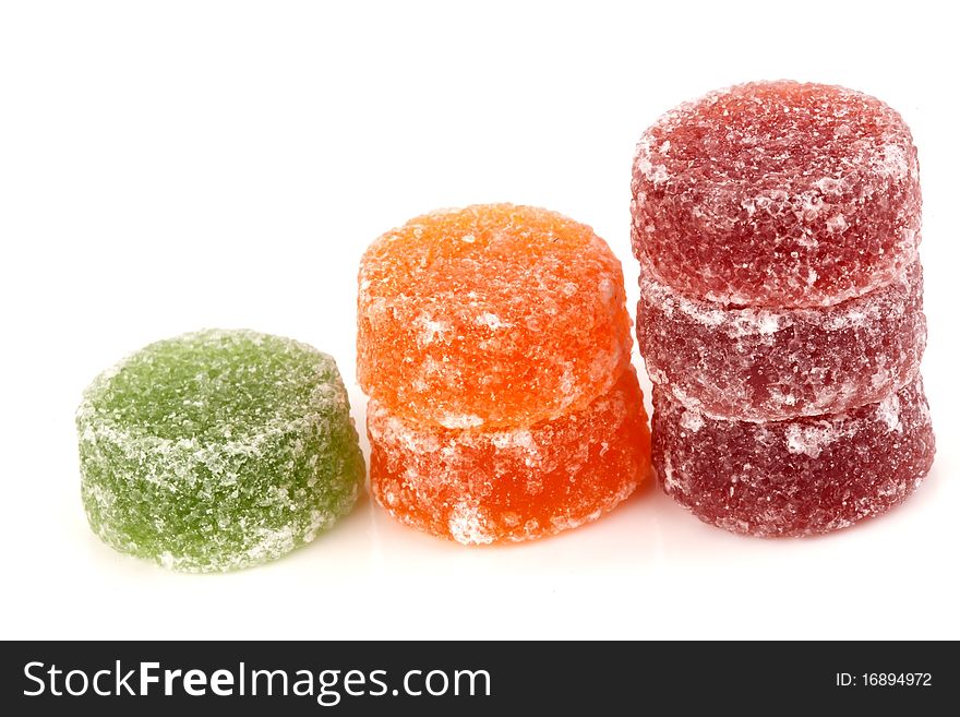 Red green and orange fruit sweets on a white background. Red green and orange fruit sweets on a white background