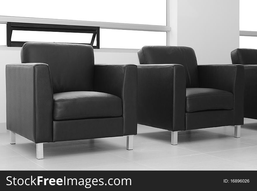 Leather seats in a hallway against a bright window. Leather seats in a hallway against a bright window.