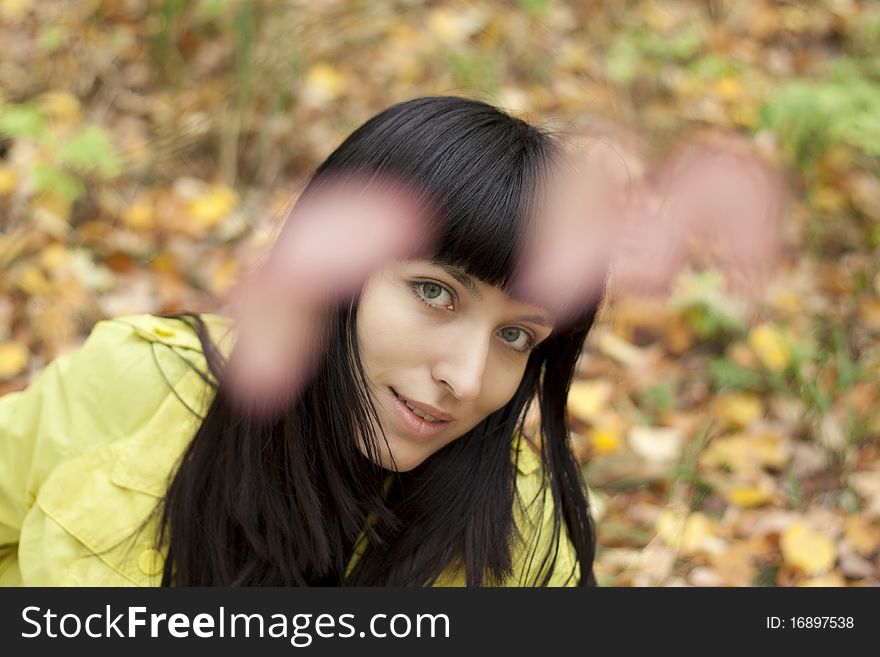 Portrait of a beautiful young woman in the autumn park. Blurred background. Portrait of a beautiful young woman in the autumn park. Blurred background.
