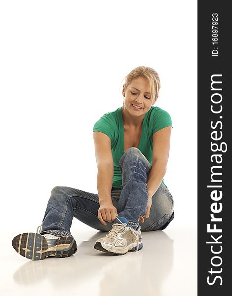 Woman sitting and tying shoe. Woman sitting and tying shoe