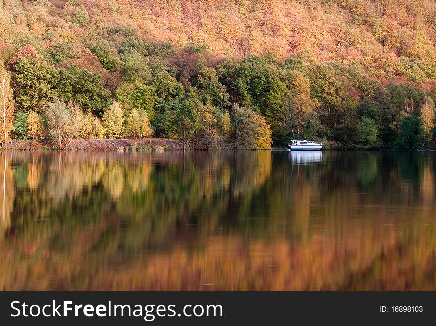 Autumn trees reflected in the river near Prague. Autumn trees reflected in the river near Prague
