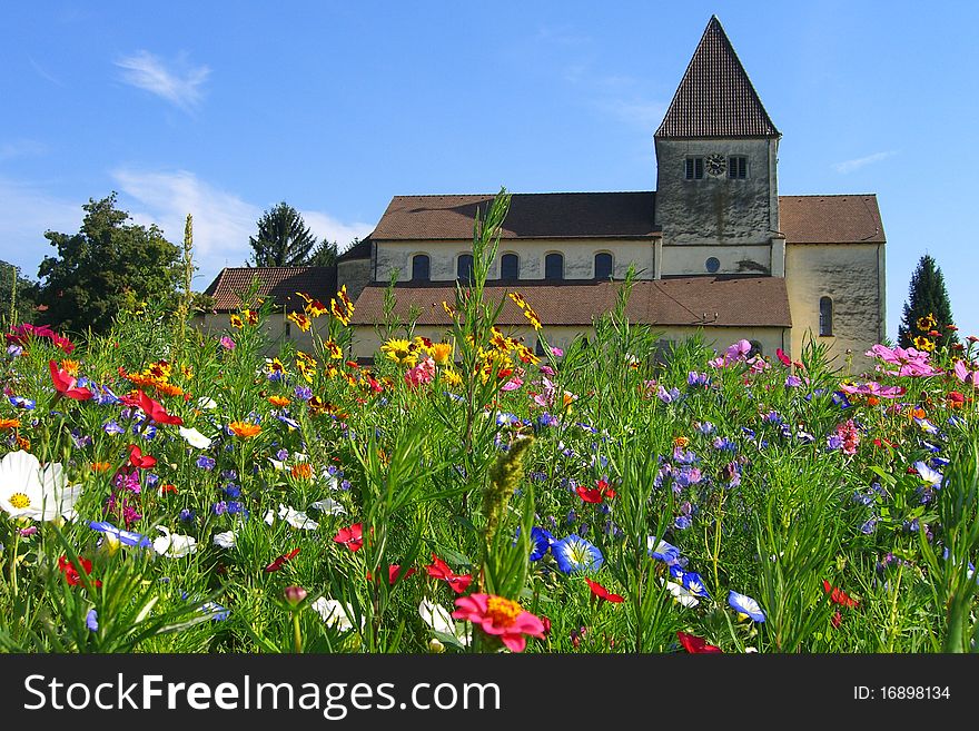 An old church surrounded by beautiful summer flowers. An old church surrounded by beautiful summer flowers