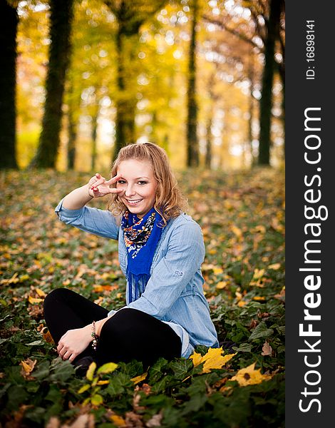 Young caucasian student girl in golden autumn park. Young caucasian student girl in golden autumn park