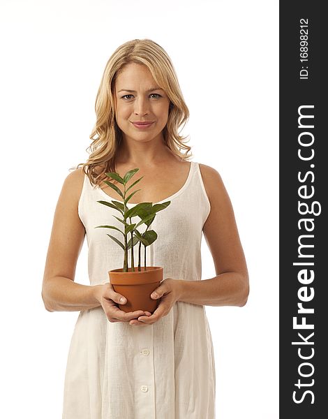 Woman standing holding potted plant. Woman standing holding potted plant