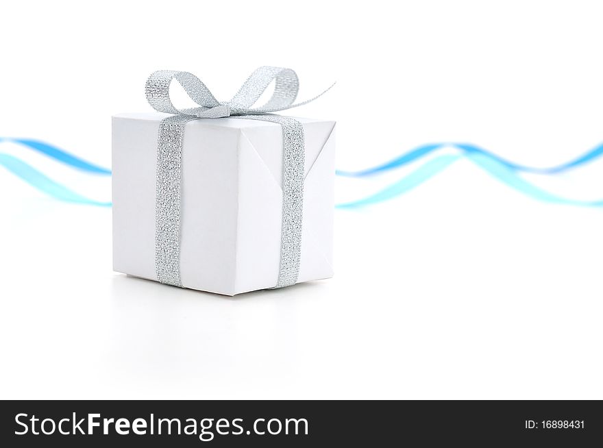 White gift box with a silver bow on white background. White gift box with a silver bow on white background