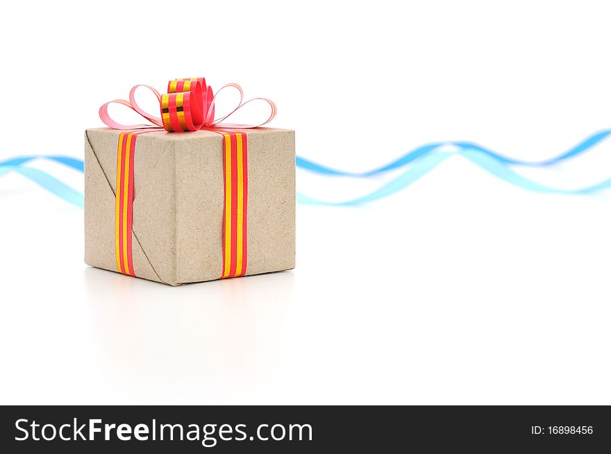 Gift box with gold and red ribbon in white background.