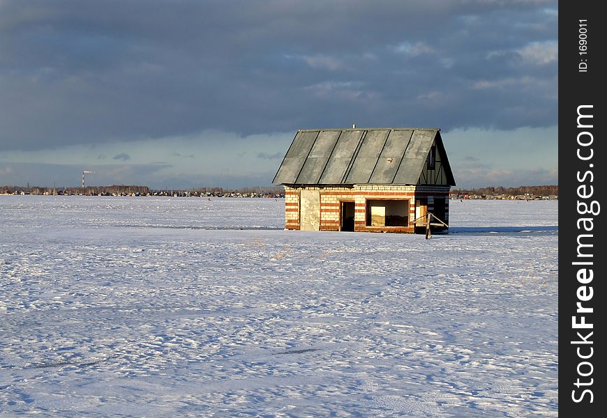 Winter lake with the flooded house on a background of the sky. Winter lake with the flooded house on a background of the sky.