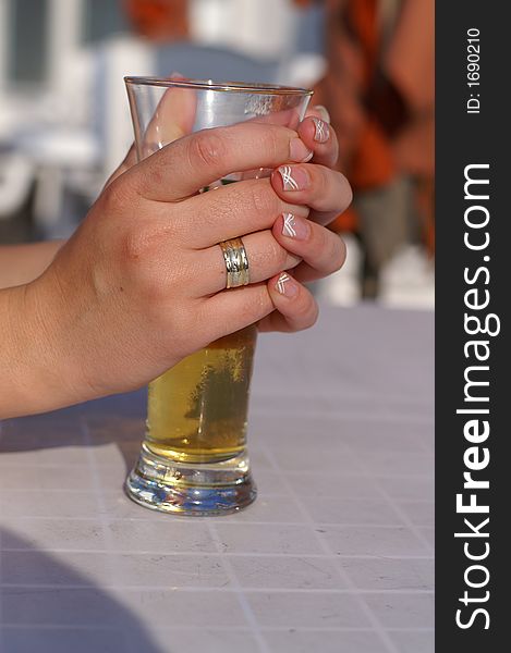 A woman drinking beer in a sunny day