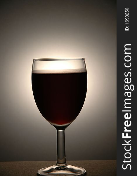 Very cold wine in a wine glass.  Frosted area visible above the whine.