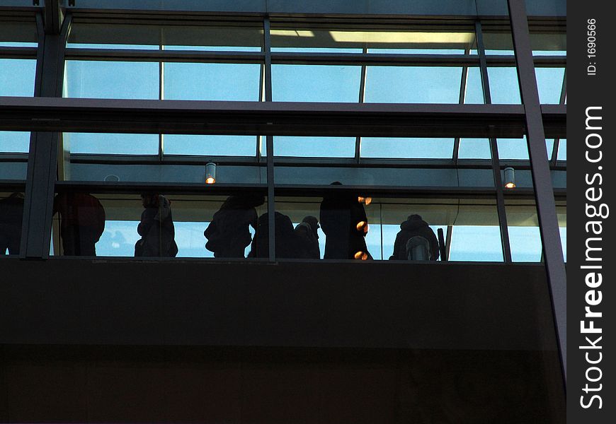 A crowd inside a modern building. A crowd inside a modern building