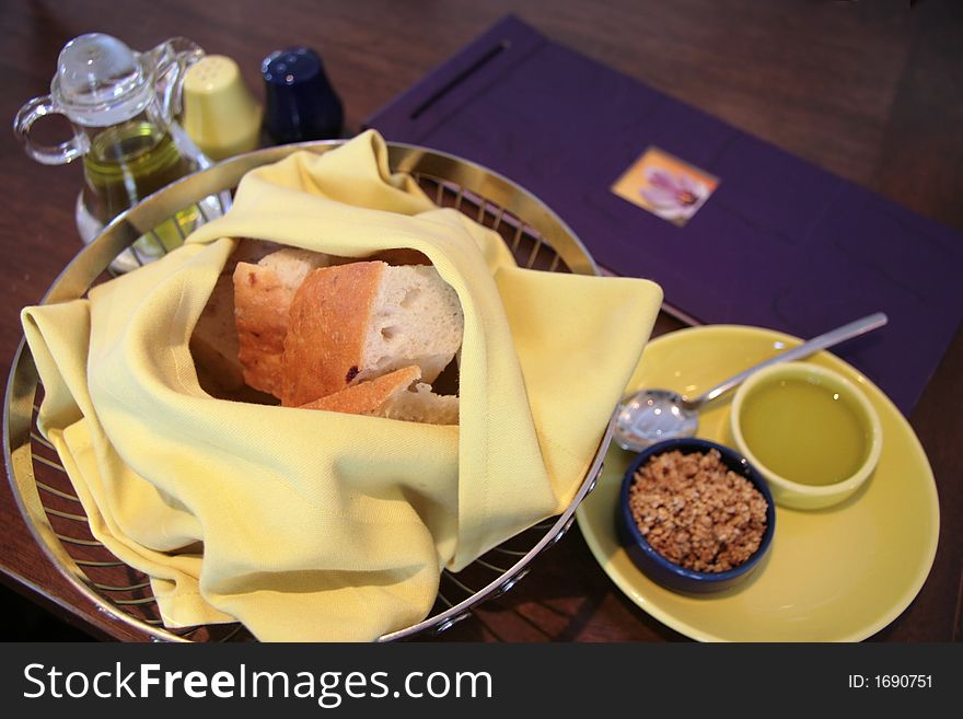 Basket of bread with olive oil and deep fried shallots. Basket of bread with olive oil and deep fried shallots