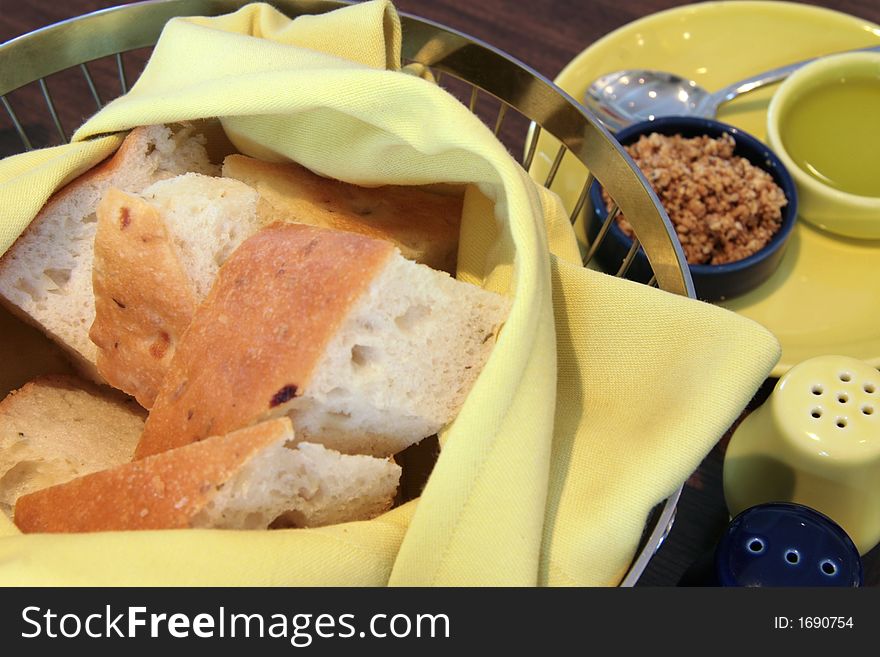 Basket of bread with olive oil and deep fried shallots. Basket of bread with olive oil and deep fried shallots