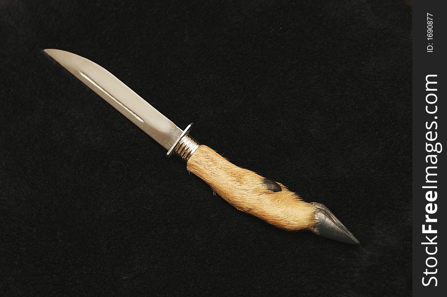 Souvenir hunting knife with the handle from a leg of a goat
