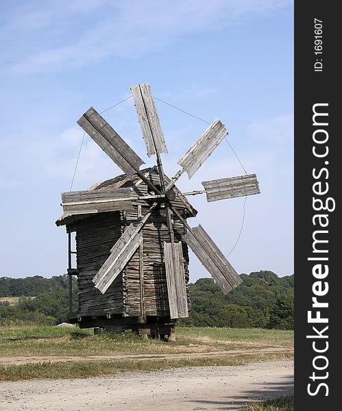 Big windmill on green field in Pirogovo, Kiev