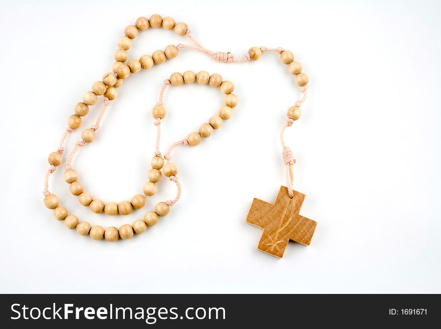 Wooden rosary on a white background. Wooden rosary on a white background