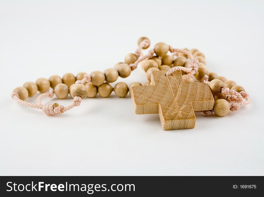 A wooden rosary on a white background. A wooden rosary on a white background