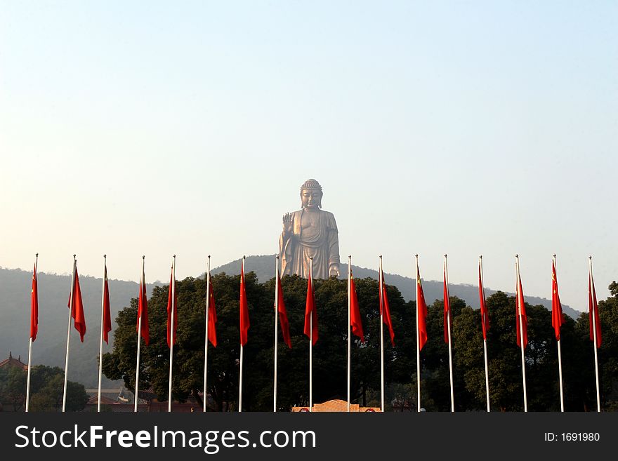 Chinese flags and Buddha statue. Chinese flags and Buddha statue