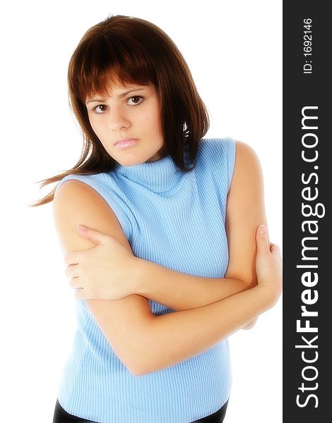 Beautiful young woman with arms crossed. Serious expression,