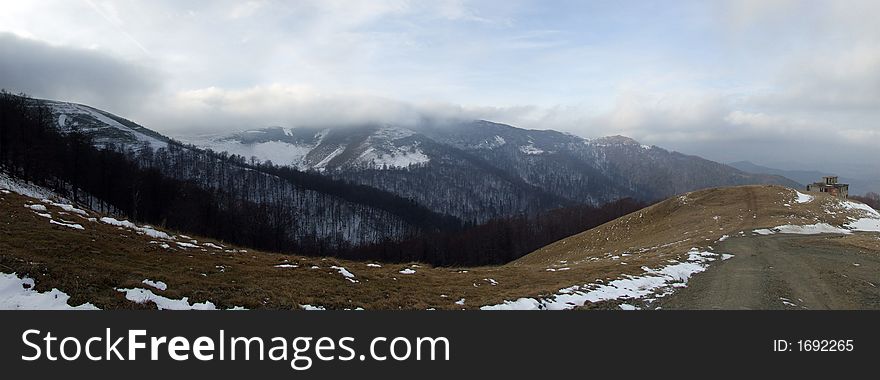 Panoramic picture of mountains with clouds floating near the mountain top. Panoramic picture of mountains with clouds floating near the mountain top