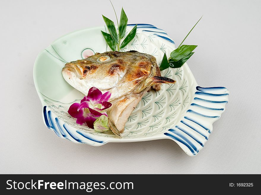 A fish dish with fish head. A fish dish with fish head