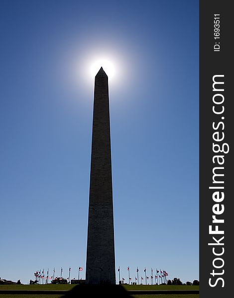 Washington Monument, Backlit By The Sun. Sun at tip.