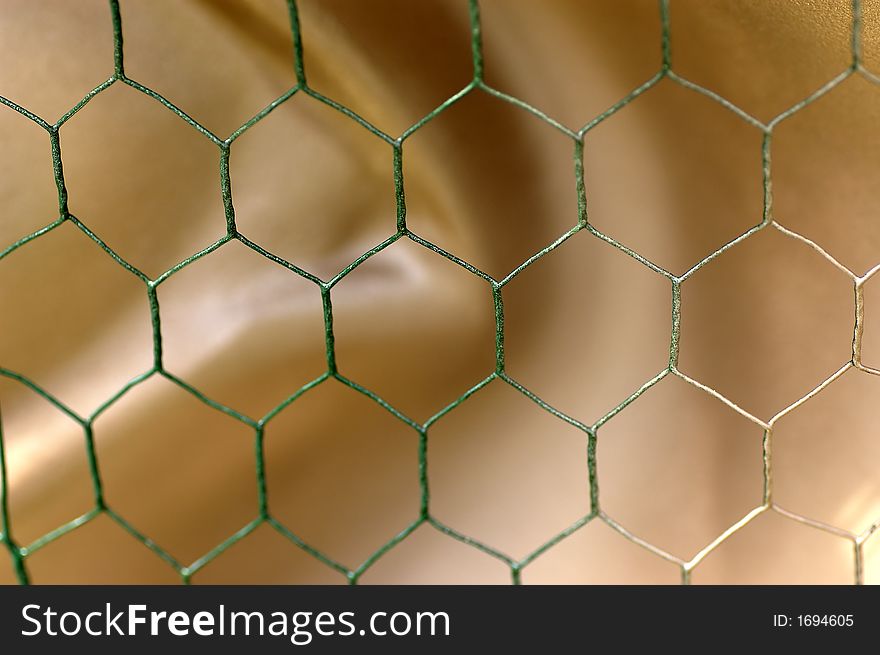 Abstract tan background with green honeycomb net