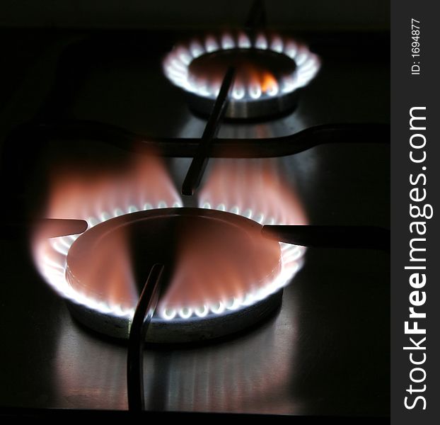 Blue Flame Of A Stove Burner In Darkness Illustrating Combustion Of Gas. Blue Flame Of A Stove Burner In Darkness Illustrating Combustion Of Gas